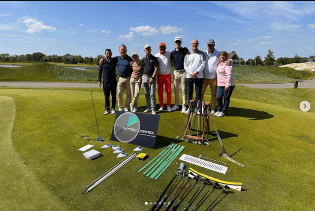 Masterclass group on the green with PuttingControl putters and training aids