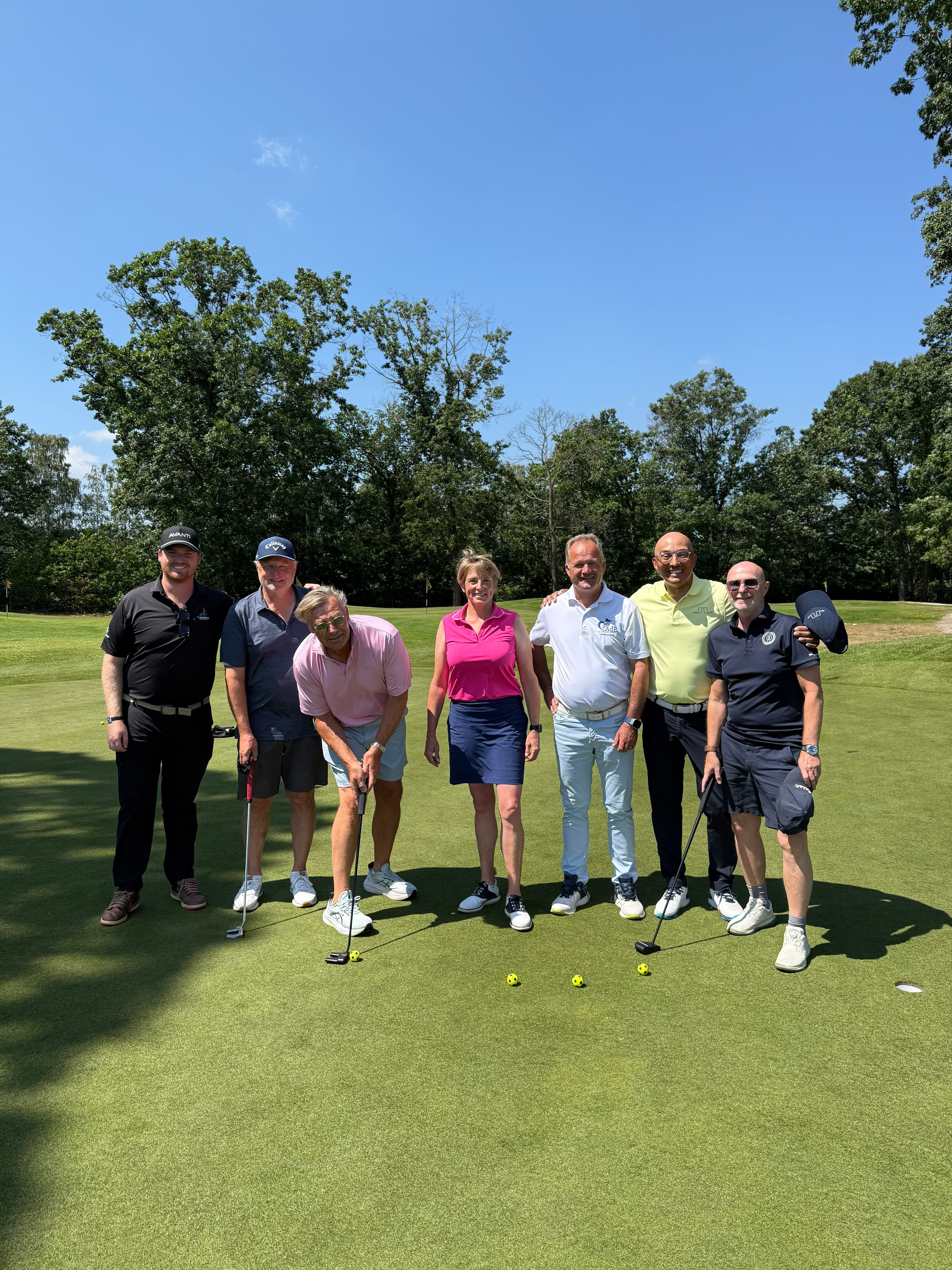 Participants in a putting masterclass on the green