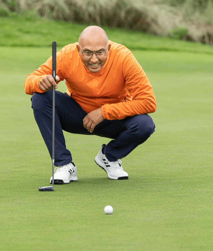 Raymond Scheffer reads a putt on the green